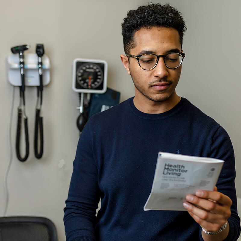 Patient of Omaha Health Clinic reading about personalized family care at the clinic.